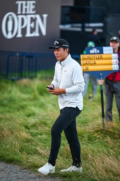 Amateur Yuxin Lin of China walks off the 18th hole green after saving par to make the cut during Day Two of the 149th The Open Championship at Royal...