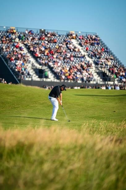 Shane Lowry of Ireland plays his approach shot on the 17th hole as fans watch from the grandstand during Day Two of the 149th The Open Championship...