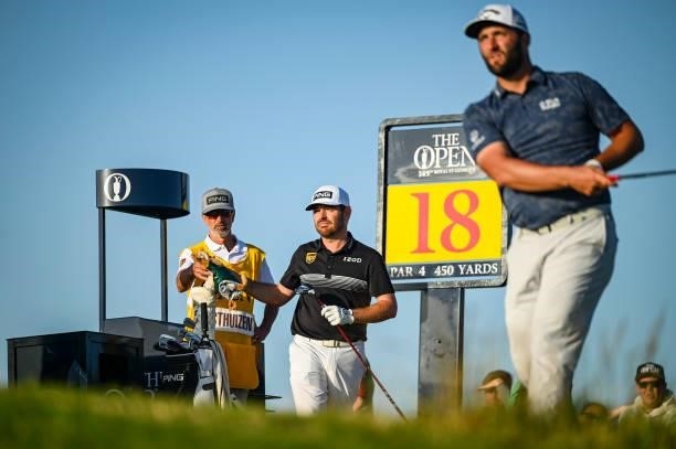Jon Rahm of Spain plays his shot from the 18th tee as Louis Oosthuizen of South Africa looks on during Day Two of the 149th The Open Championship at...