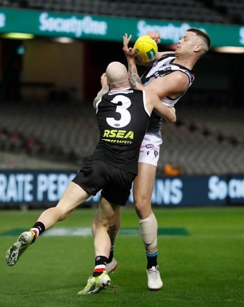 Peter Ladhams of the Power is tackled by Zak Jones of the Saints during the 2021 AFL Round 18 match between the St Kilda Saints and the Port Adelaide...