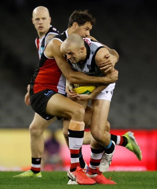 Jarrod Lienert of the Power is tackled by Paddy Ryder of the Saints during the 2021 AFL Round 18 match between the St Kilda Saints and the Port...