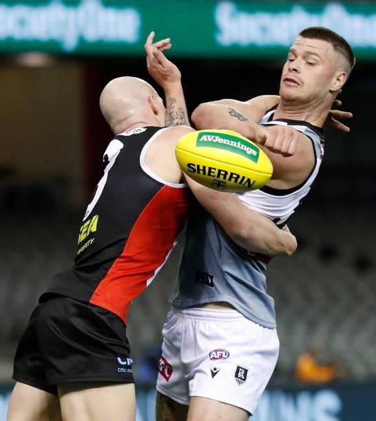 Peter Ladhams of the Power is tackled by Zak Jones of the Saints during the 2021 AFL Round 18 match between the St Kilda Saints and the Port Adelaide...