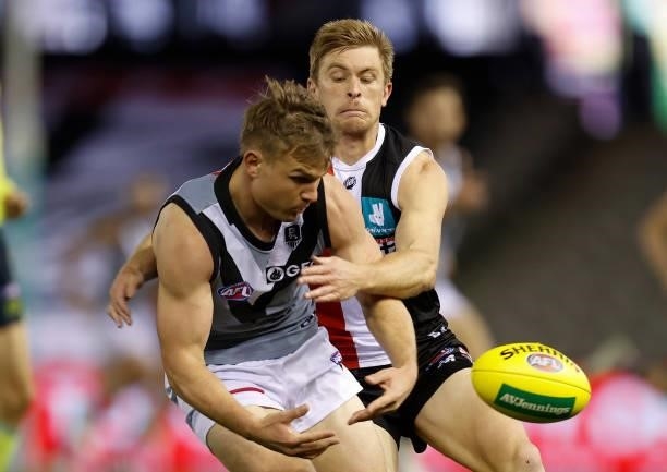 Ollie Wines of the Power and Sebastian Ross of the Saints in action during the 2021 AFL Round 18 match between the St Kilda Saints and the Port...
