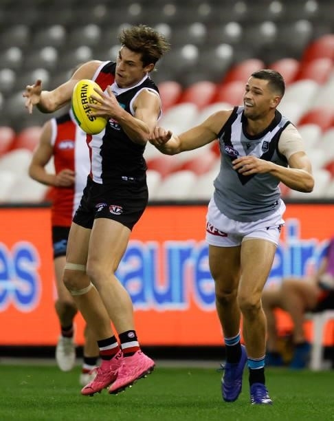 Jack Steele of the Saints and Ryan Burton of the Power in action during the 2021 AFL Round 18 match between the St Kilda Saints and the Port Adelaide...