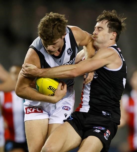 Daniel McKenzie of the Saints tackles Mitch Georgiades of the Power during the 2021 AFL Round 18 match between the St Kilda Saints and the Port...