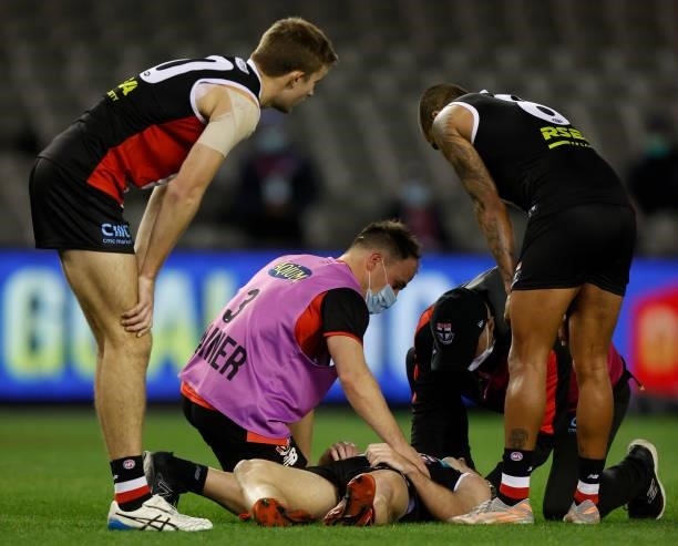 Daniel McKenzie of the Saints lays injured after tackling Mitch Georgiades of the Power during the 2021 AFL Round 18 match between the St Kilda...