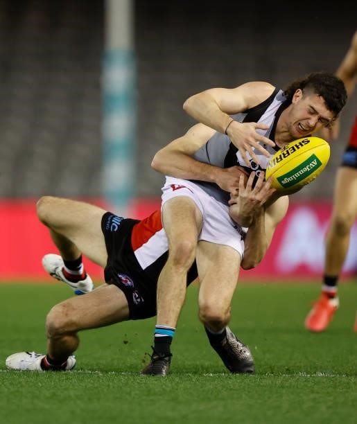 Darcy Byrne-Jones of the Power is tackled by Brad Crouch of the Saints during the 2021 AFL Round 18 match between the St Kilda Saints and the Port...