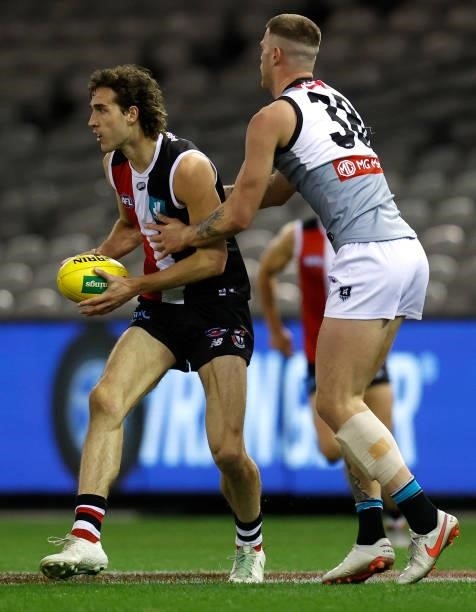 Max King of the Saints is tackled by Peter Ladhams of the Power during the 2021 AFL Round 18 match between the St Kilda Saints and the Port Adelaide...