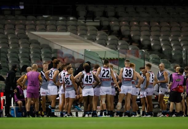 Michael Voss, Senior Assistant Coach of the Power speaks with players as Daniel McKenzie of the Saints is stretchered from the field during the 2021...