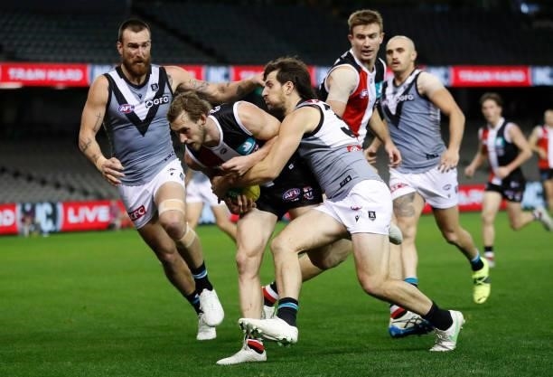 Jimmy Webster of the Saints is tackled by Sam Mayes of the Power during the 2021 AFL Round 18 match between the St Kilda Saints and the Port Adelaide...