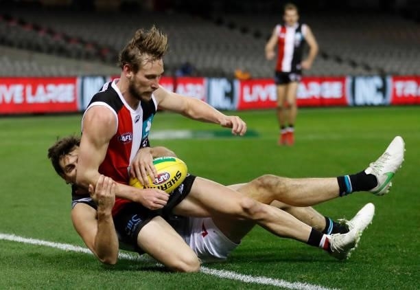 Jimmy Webster of the Saints is tackled by Sam Mayes of the Power during the 2021 AFL Round 18 match between the St Kilda Saints and the Port Adelaide...