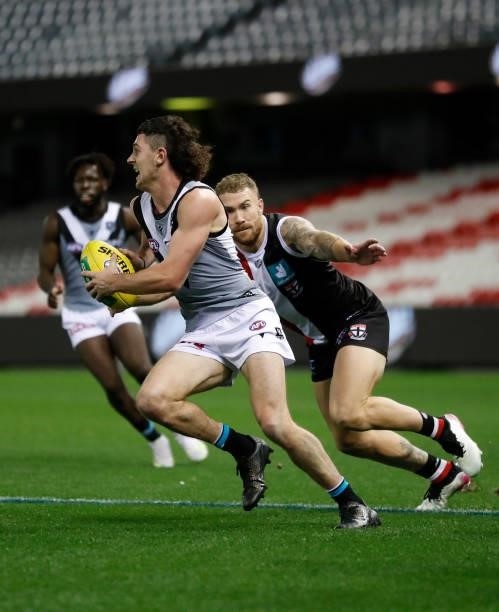 Darcy Byrne-Jones of the Power is tackled by Dean Kent of the Saints during the 2021 AFL Round 18 match between the St Kilda Saints and the Port...