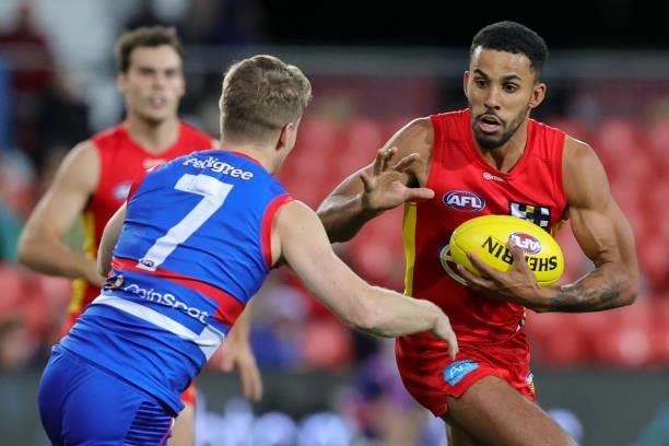 Touk Miller of the Suns looks to evade a tackle during the 2021 AFL Round 18 match between the Gold Coast Suns and the Western Bulldogs at Metricon...