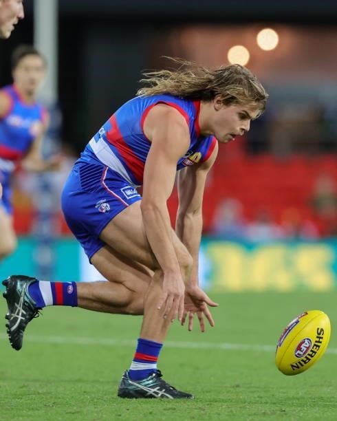Bailey Smith of the Bulldogs attempts to pick the ball up during the 2021 AFL Round 18 match between the Gold Coast Suns and the Western Bulldogs at...