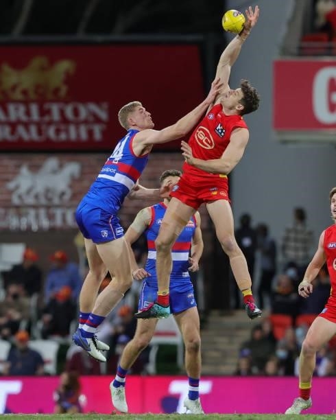 Tim English of the Bulldogs and Chris Burgess of the Suns contest the ruck during the 2021 AFL Round 18 match between the Gold Coast Suns and the...