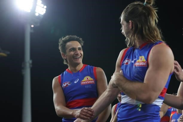Josh Bruce and Jamarra Ugle-Hagan of the Bulldogs share a laugh after the 2021 AFL Round 18 match between the Gold Coast Suns and the Western...