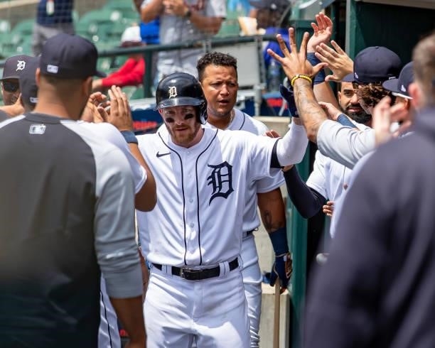 Robbie Grossman of the Detroit Tigers hi-fives teammates after hitting a solo home run in the first inning against the Minnesota Twins during game...
