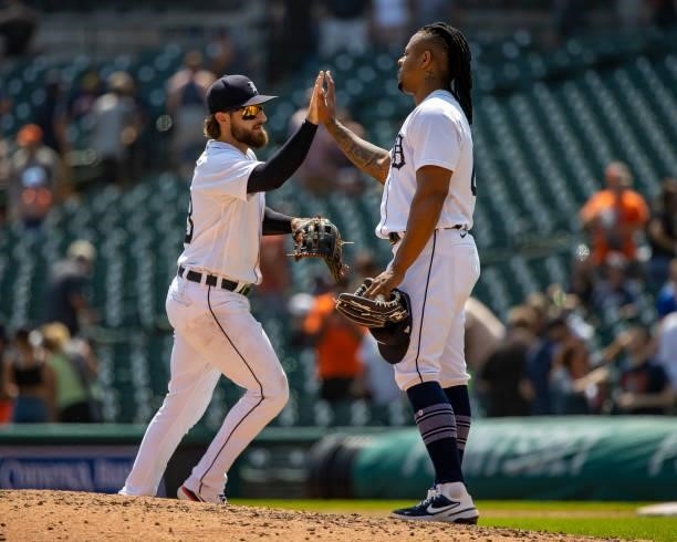 Relief pitcher Gregory Soto of the Detroit Tigers hi-fives teammate Eric Haase after game one of a double header against the Minnesota Twins at...