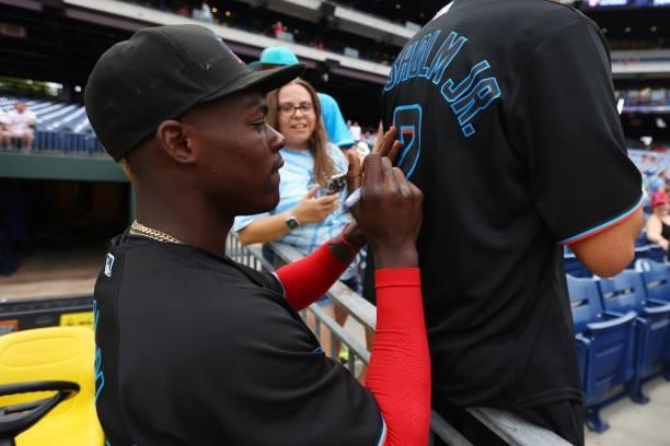 Jazz Chisholm Jr. #2 of the Miami Marlins signs autographs a fans jersey before a game against the Philadelphia Phillies at Citizens Bank Park on...