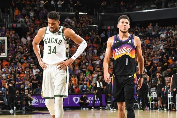 Giannis Antetokounmpo of the Milwaukee Bucks and Devin Booker of the Phoenix Suns look on during Game Five of the 2021 NBA Finals on July 17, 2021 at...