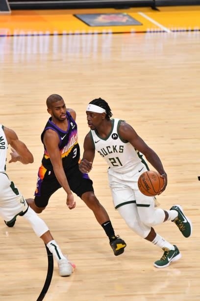 Jrue Holiday of the Milwaukee Bucks handles the ball against Chris Paul of the Phoenix Suns during Game Five of the 2021 NBA Finals on July 17, 2021...