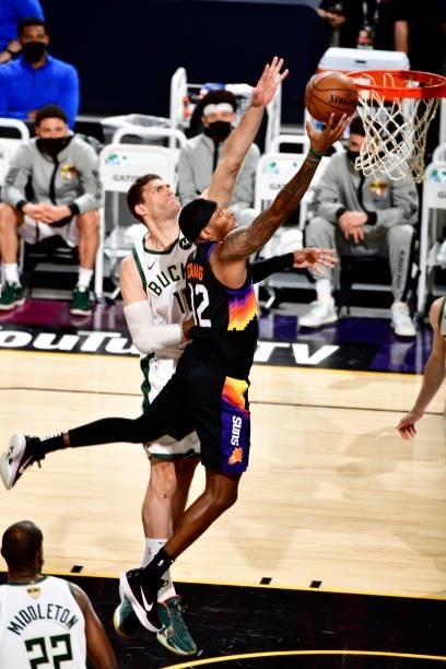Torrey Craig of the Phoenix Suns drives to the basket against the Milwaukee Bucks on July 17, 2021 during Game Five of the NBA Finals at Footprint...