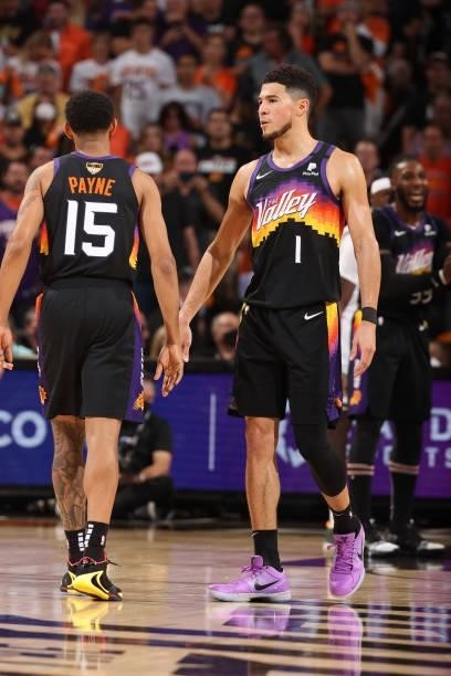 July 17: Devin Booker of the Phoenix Suns high fives Cameron Payne of the Phoenix Suns during Game Five of the 2021 NBA Finals on July 17, 2021 at...