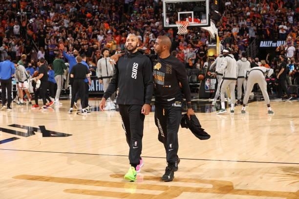 July 17: Chris Paul of the Phoenix Suns talks with Jevon Carter of the Phoenix Suns prior to the game against the Milwaukee Bucks during Game Five of...