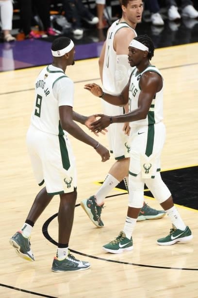 July 17: Jrue Holiday of the Milwaukee Bucks celebrates with teammate Bobby Portis during the game against the Phoenix Suns during Game Five of the...
