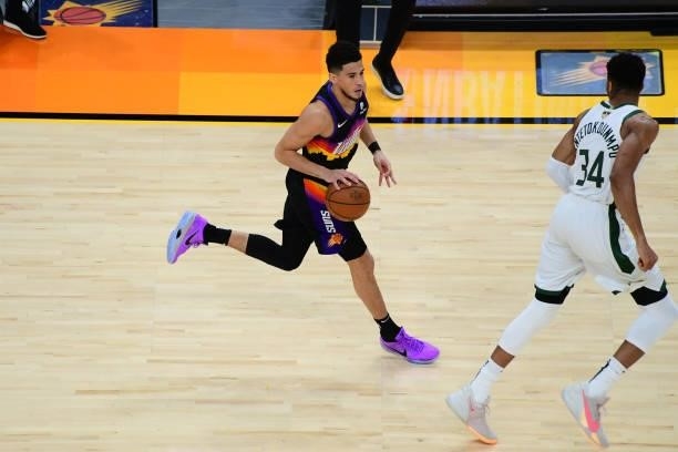 July 17: Devin Booker of the Phoenix Suns dribbles the ball against the Milwaukee Bucks during Game Five of the 2021 NBA Finals on July 17, 2021 at...
