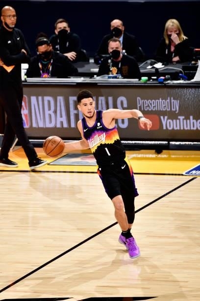 Devin Booker of the Phoenix Suns passes the ball against the Milwaukee Bucks on July 17, 2021 during Game Five of the NBA Finals at Footprint Center...