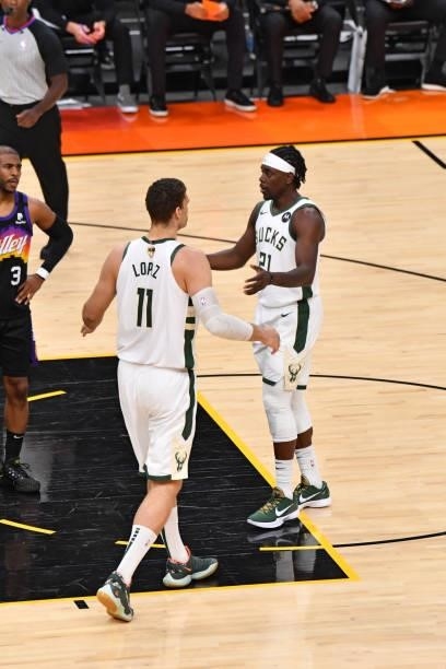 Brook Lopez of the Milwaukee Bucks and Jrue Holiday of the Milwaukee Bucks high-five during Game Five of the 2021 NBA Finals on July 17, 2021 at...