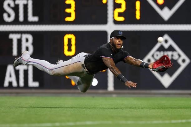 Right fielder Monte Harrison of the Miami Marlins makes a diving catch on a ball hit by Luke Williams of the Philadelphia Phillies to end the ninth...
