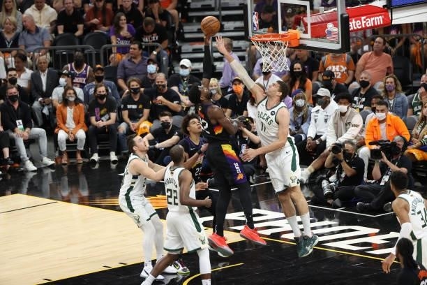 July 17: Brook Lopez of the Milwaukee Bucks reaches to block a shot by Deandre Ayton of the Phoenix Suns during Game Five of the 2021 NBA Finals on...