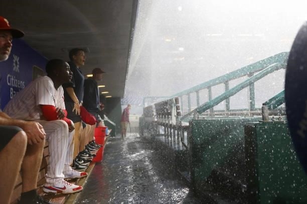Didi Gregorius of the Philadelphia Phillies sits in the dugout during a thunder storm that interupted play during the tenth inning of a game against...