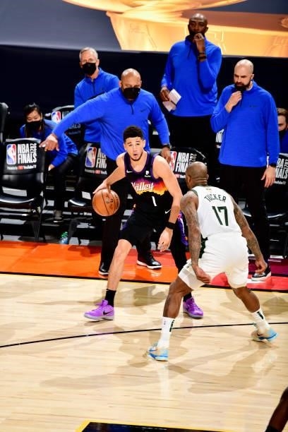 Devin Booker of the Phoenix Suns dribbles during the game against the Milwaukee Bucks on July 17, 2021 during Game Five of the NBA Finals at...