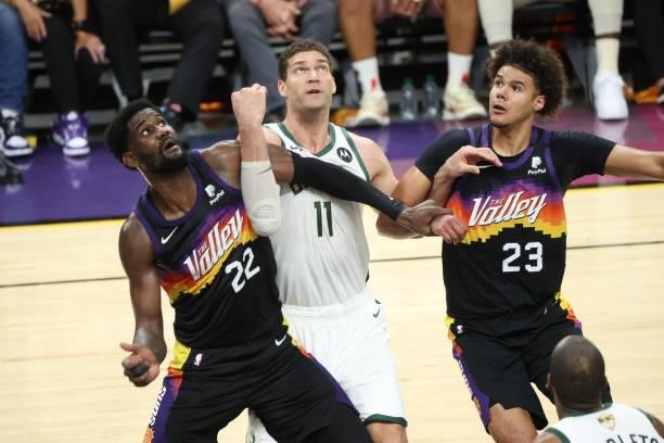 July 17: Deandre Ayton and Cameron Johnson of the Phoenix Suns and Brook Lopez of the Milwaukee Bucks fight for position during Game Five of the 2021...