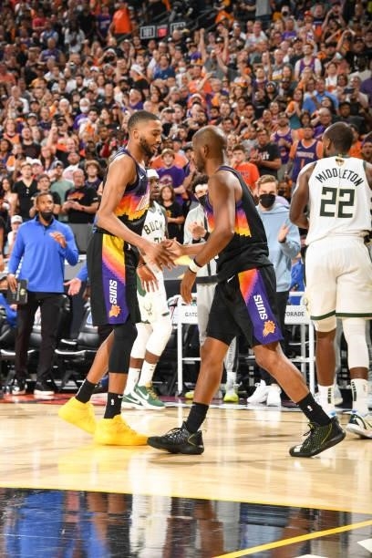 Chris Paul of the Phoenix Suns high fives Mikal Bridges of the Phoenix Suns during the game against the Milwaukee Bucks during Game Five of the 2021...