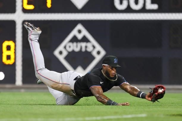 Right fielder Monte Harrison of the Miami Marlins makes a diving catch on a ball hit by Luke Williams of the Philadelphia Phillies to end the ninth...