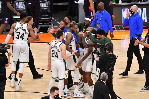 Khris Middleton of the Milwaukee Bucks and the Milwaukee Bucks react during Game Five of the 2021 NBA Finals on July 17, 2021 at Footprint Center in...