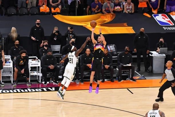 Devin Booker of the Phoenix Suns shoots a three-pointer against the Milwaukee Bucks during Game Five of the 2021 NBA Finals on July 17, 2021 at...