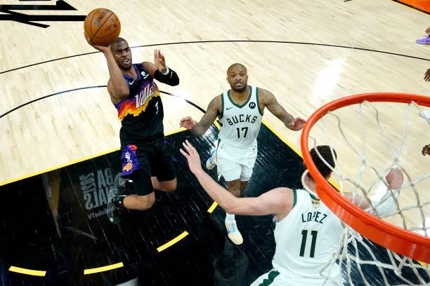 Phoenix Suns guard Chris Paul shoots as Milwaukee Bucks forward P.J. Tucker and center Brook Lopez defends during the first half of Game Five of the...