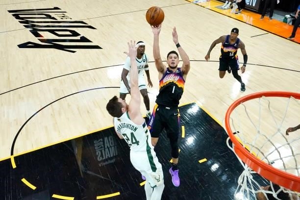 Phoenix Suns guard Devin Booker shoots over Milwaukee Bucks guard Pat Connaughton during the first half of Game Five of the 2021 NBA Finals on July...