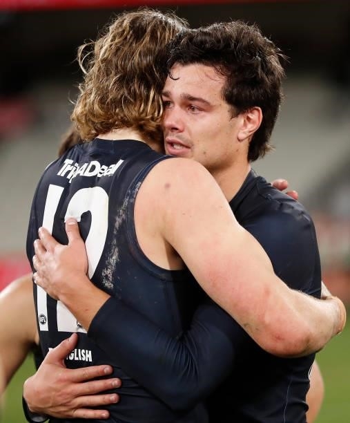 Jack Silvagni of the Blues is consoled by teammate Tom De Koning during the 2021 AFL Round 18 match between the Collingwood Magpies and the Carlton...