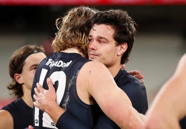 Jack Silvagni of the Blues is consoled by teammate Tom De Koning during the 2021 AFL Round 18 match between the Collingwood Magpies and the Carlton...