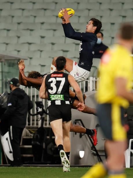 Jack Silvagni of the Blues takes a spectacular mark over Isaac Quaynor of the Magpies during the 2021 AFL Round 18 match between the Collingwood...