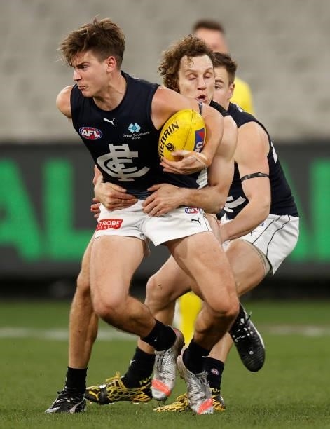 Paddy Dow of the Blues is tackled by Chris Mayne of the Magpies during the 2021 AFL Round 18 match between the Collingwood Magpies and the Carlton...