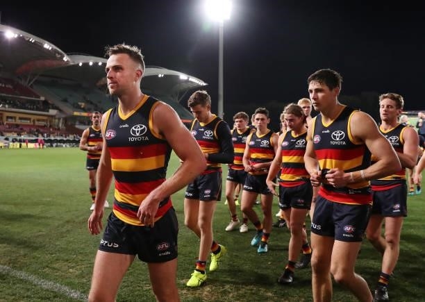 Brodie Smith of the Crows leads the team off after the loss and in his 200th game during the 2021 AFL Round 18 match between the Adelaide Crows and...