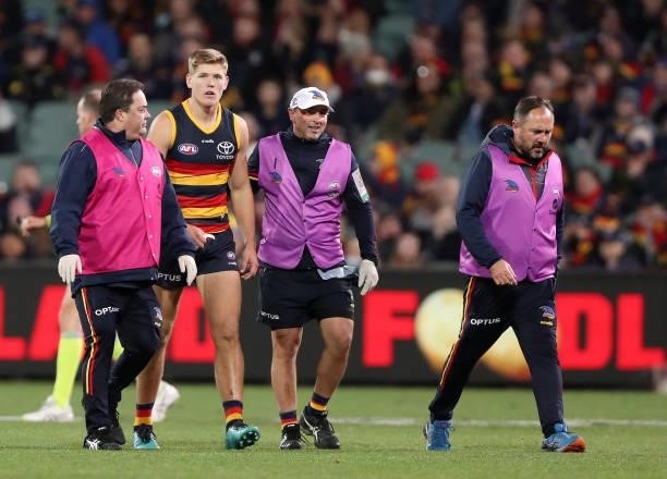 Nick Murray of the Adelaide Crows is taken from the oval and subbed out with concussion during the 2021 AFL Round 18 match between the Adelaide Crows...