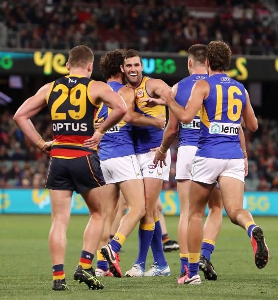 Jack Petruccelle of the Eagles celebrates a goal with Jack Darling while Rory Laird of the Crows puts his hands on his hips during the 2021 AFL Round...